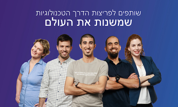 Group of people standing together smiling.